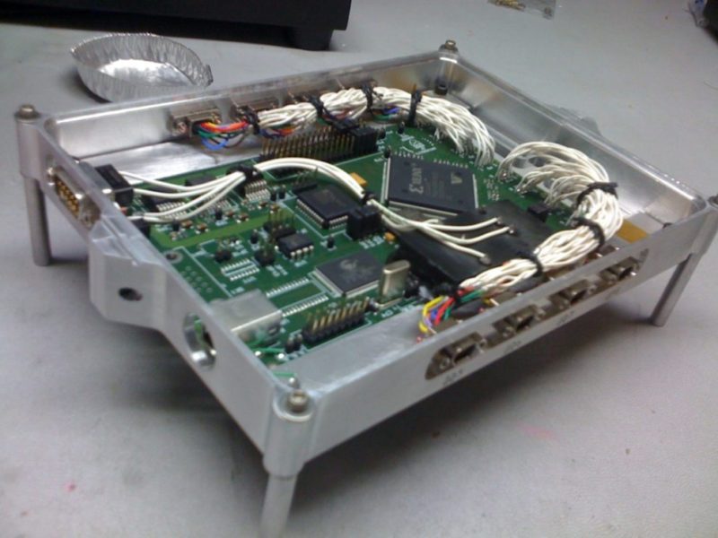 A circuit board prototype being installed into a custom housing.